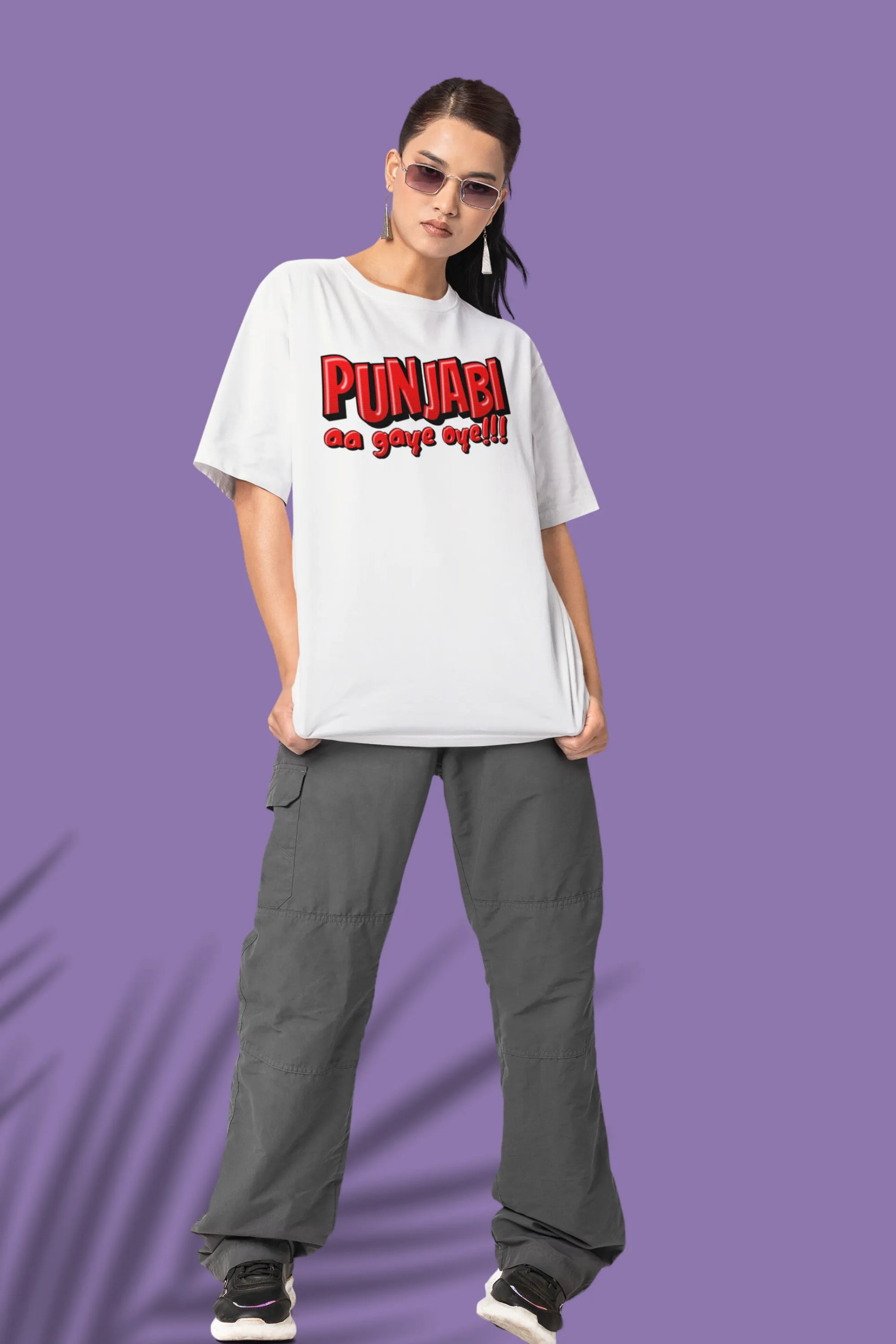 Third front view of a female model wearing an off-white oversized t-shirt with the text "Punjabi Aa Gaye Oye".
