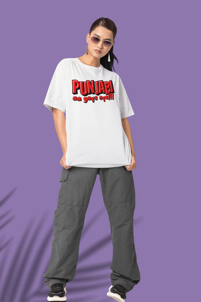 Third front view of a female model wearing an off-white oversized t-shirt with the text "Punjabi Aa Gaye Oye".