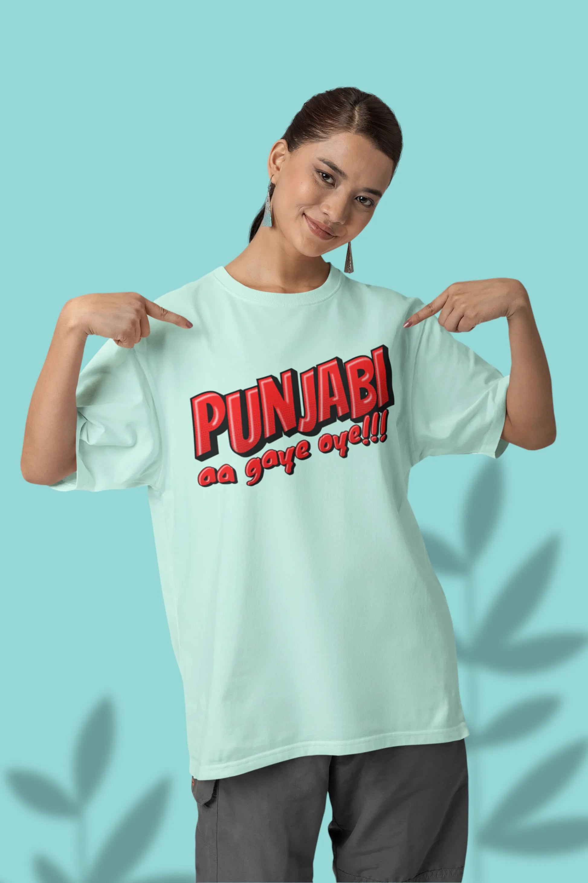 First front view of a female model wearing an mint-green oversized t-shirt with the text "Punjabi Aa Gaye Oye".