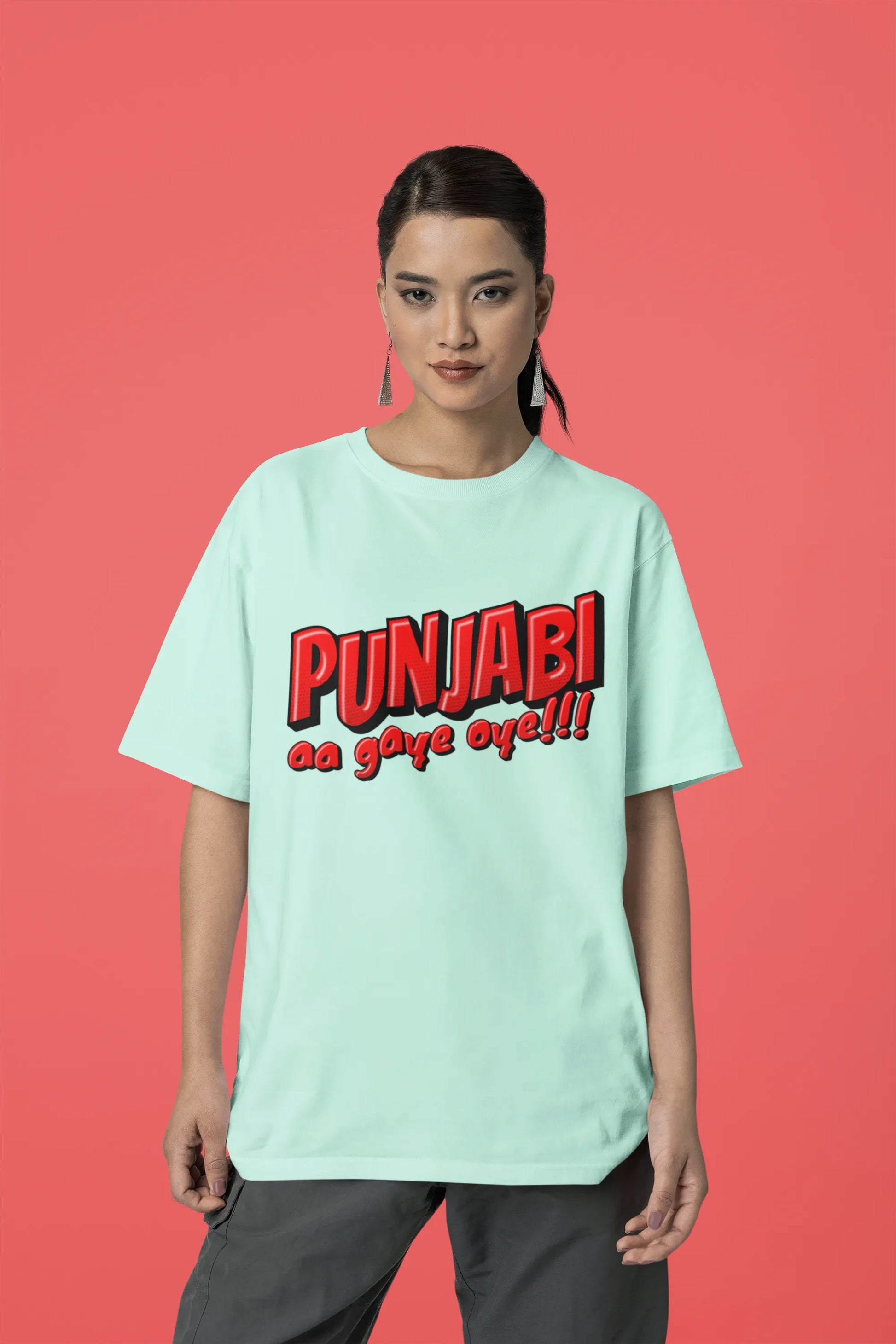 Third front view of a female model wearing an mint-green oversized t-shirt with the text "Punjabi Aa Gaye Oye".