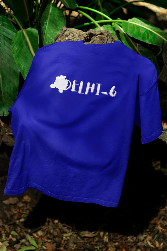Front view of a royal blue oversized t-shirt featuring a design incorporating the Red Fort and elements representing the city of Delhi, inspired by the Hindi film Delhi 6.