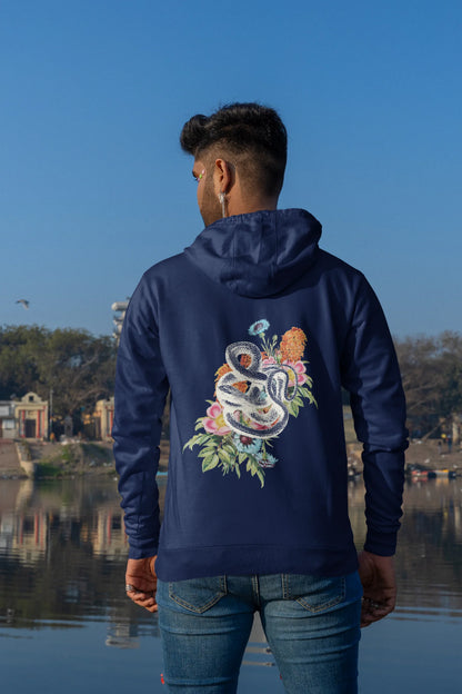 Back of male model wearing a navy blue hoodie with a snake coiled around flowers, symbolizing the harmony between nature and its creatures.