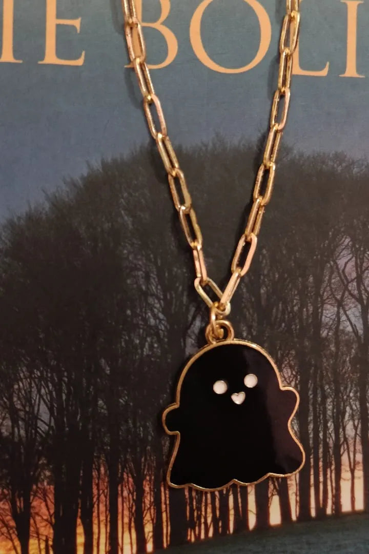 Third view of an anti tarnish gold chain necklace featuring a cute black ghost design.