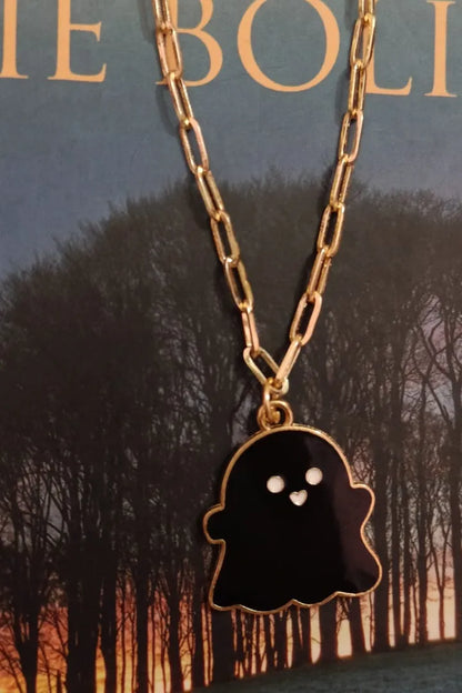Third view of an anti tarnish gold chain necklace featuring a cute black ghost design.