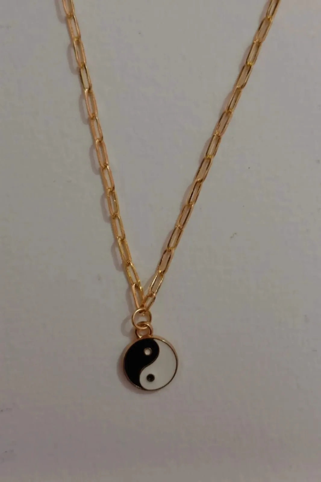 Fourth image of a yin and yang gold chain.