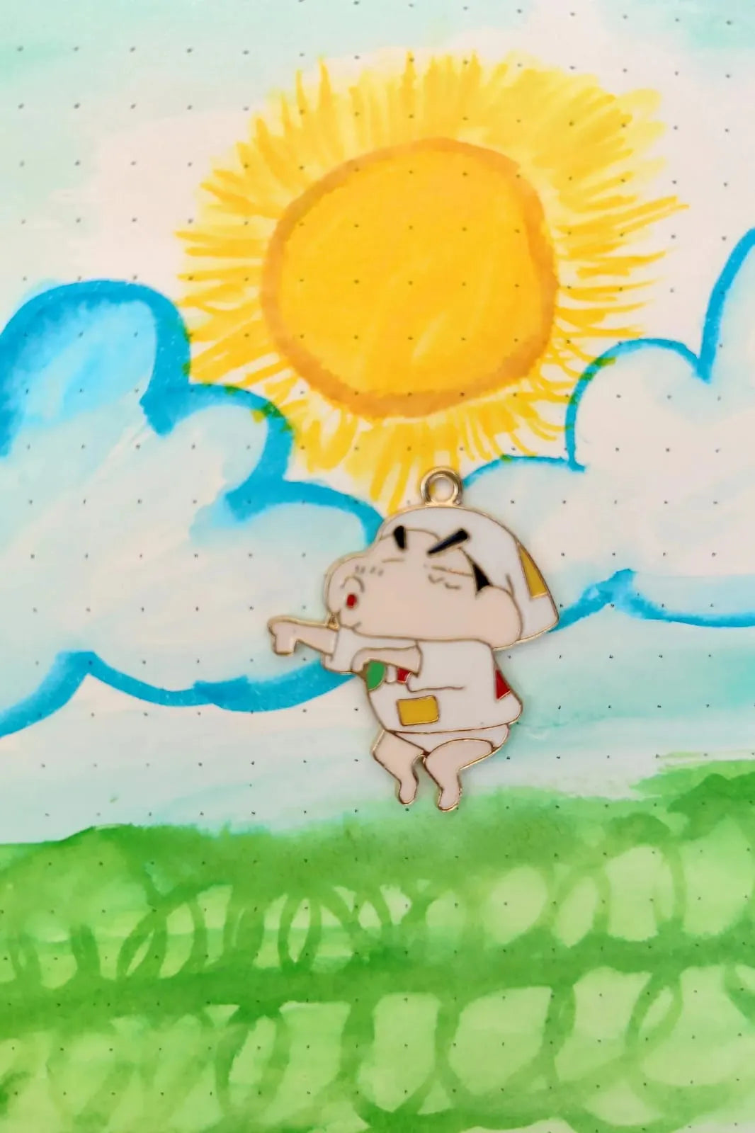 First view of a charm featuring a mischievous Shinchan design.