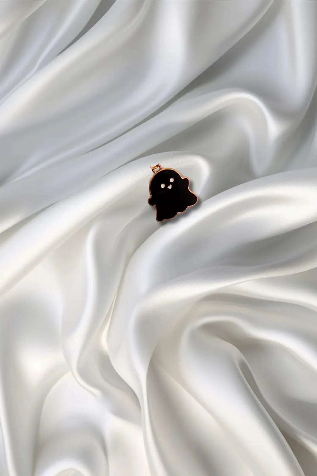Third view of a charm featuring a cute black spooky adorable ghost design.