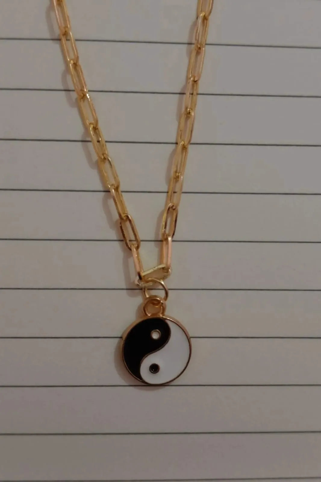 Third image of a yin and yang gold chain.