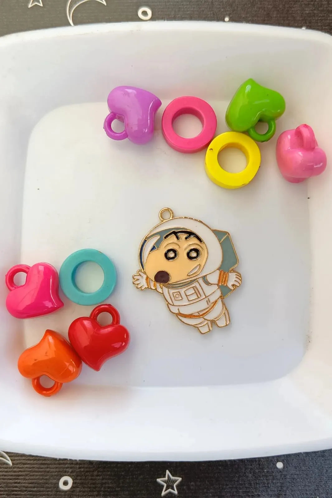 First view of a cute charm featuring Shinchan in a space suit, exploring the cosmos.