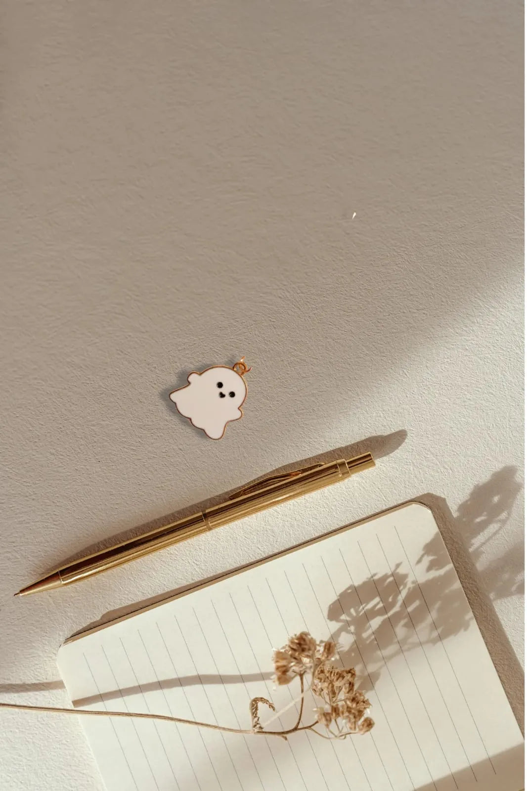 Third view of a charm featuring a cute white spooky adorable ghost design.