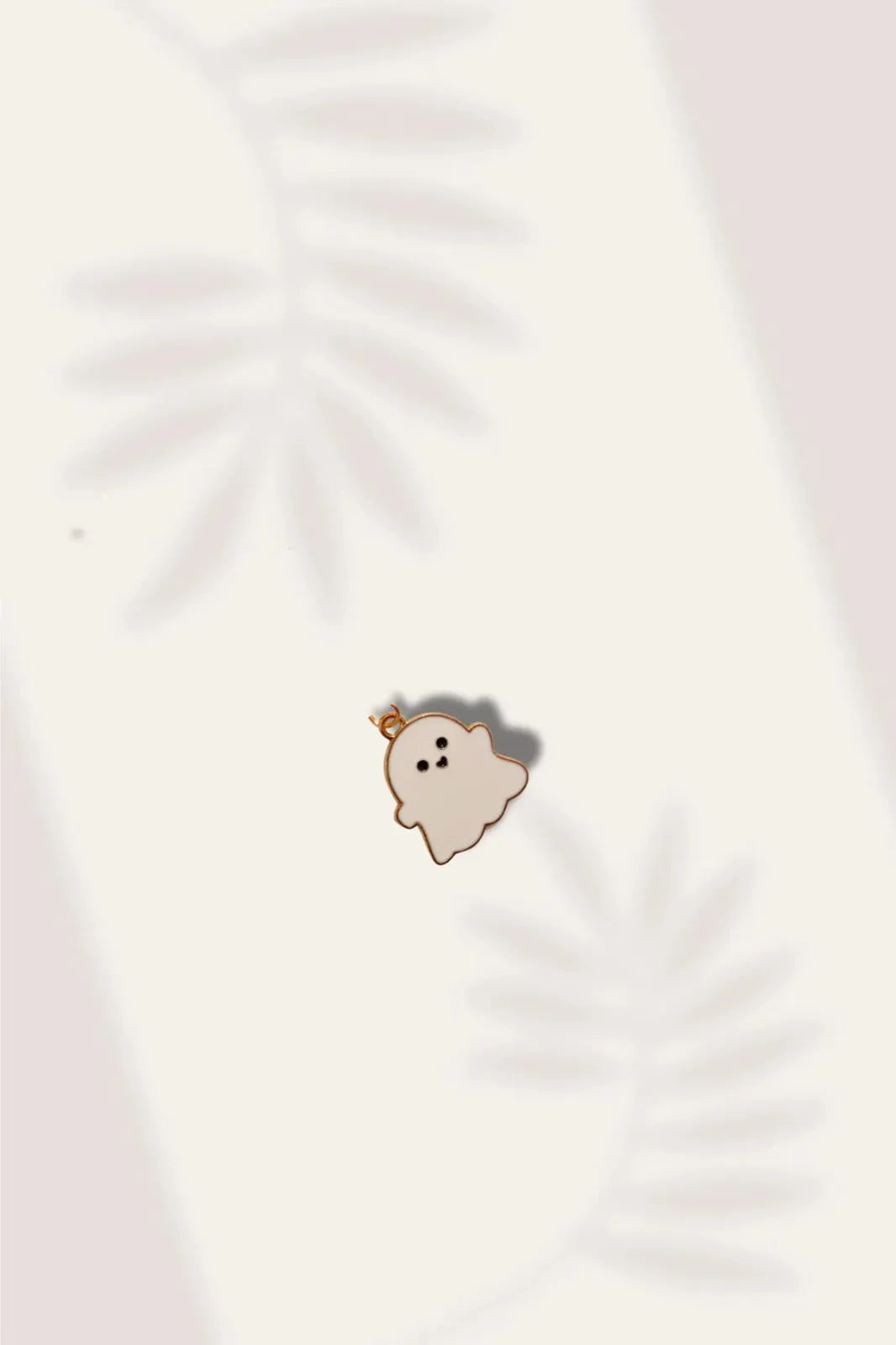 Third view of a charm featuring a cute white spooky adorable ghost design.