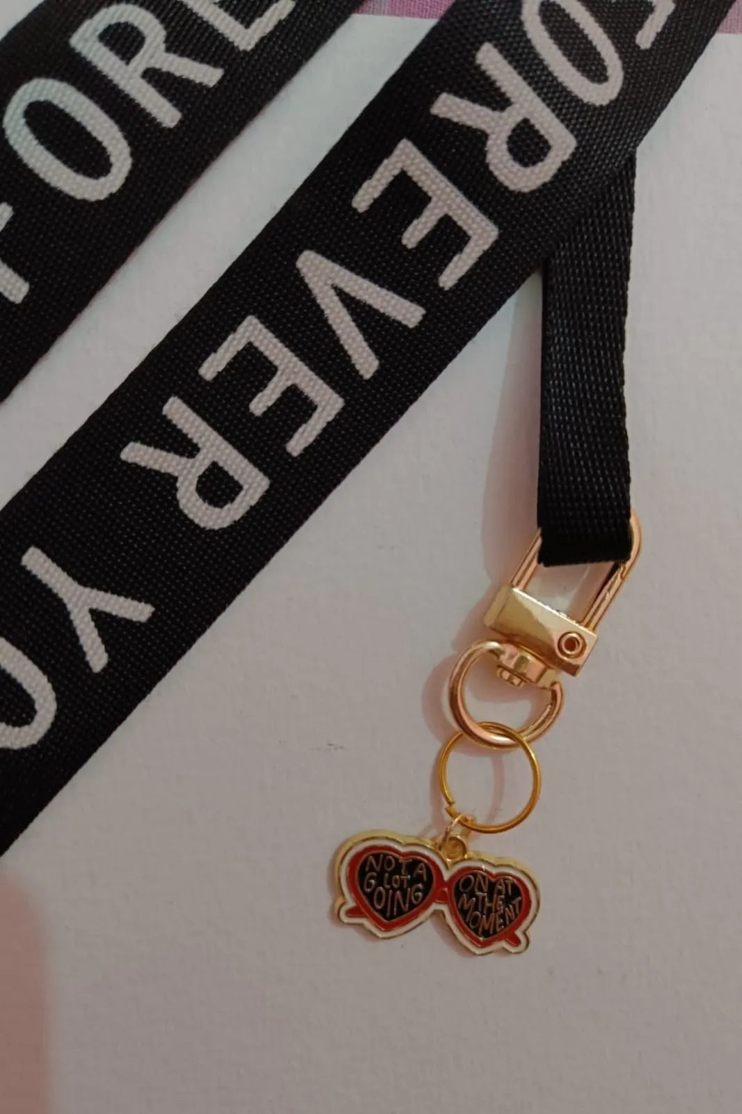 Third view of a keychain featuring a design inspired by Taylor Swift's "Evermore" album. Perfect for all swifties.