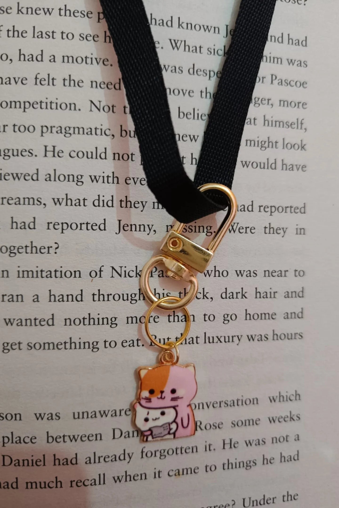 Third view of a keychain featuring a design of a mother cat and her kitten.