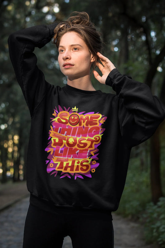 Second front view of a female model wearing an black sweatshirt featuring the designs inspired from Coldplay's "Something Just Like This" music video.