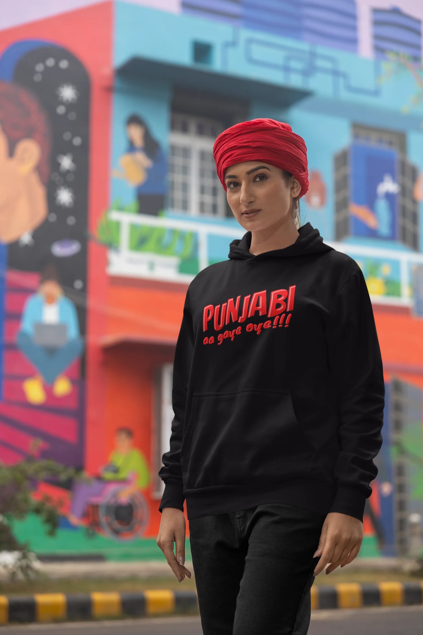 Second front view of a female model wearing an black hoodie with the text "Punjabi Aa Gaye".