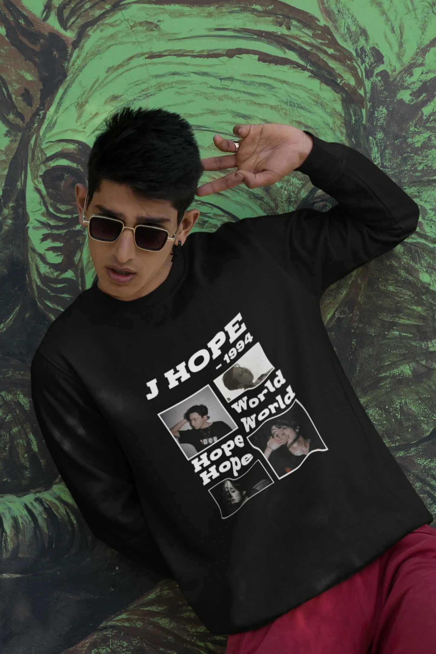 Third front view of a male model wearing a black sweatshirt featuring a vibrant design inspired by BTS member J-Hope (Hoseok). Ideal for BTS fans (ARMY) and K-Pop enthusiasts who love dance and rap-focused music.