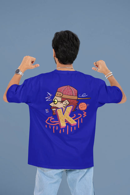 Back view of a male model wearing a royal blue oversized t-shirt featuring the Hindi word for "cool" with a unique, playful design.