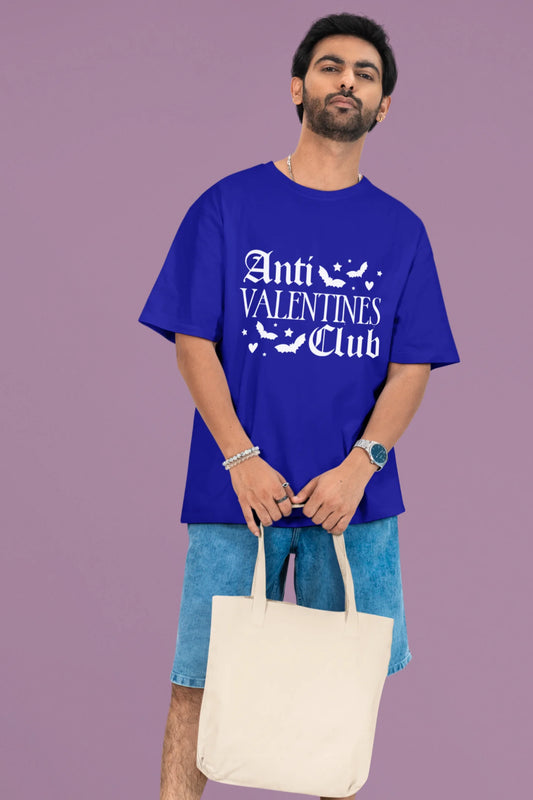 First front view of a male model wearing a royal blue oversized t-shirt with the text "Anti-Valentine's Club" printed on it.