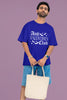 First front view of a male model wearing a royal blue oversized t-shirt with the text 