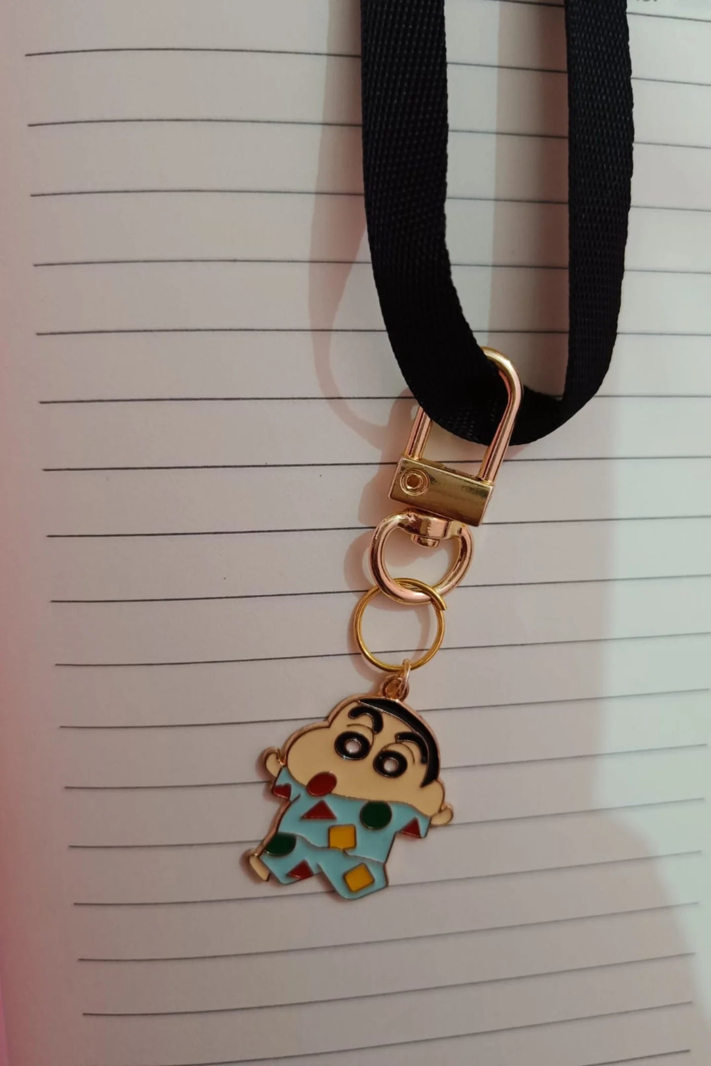 First view of a keychain featuring Shinchan waking up in the morning.