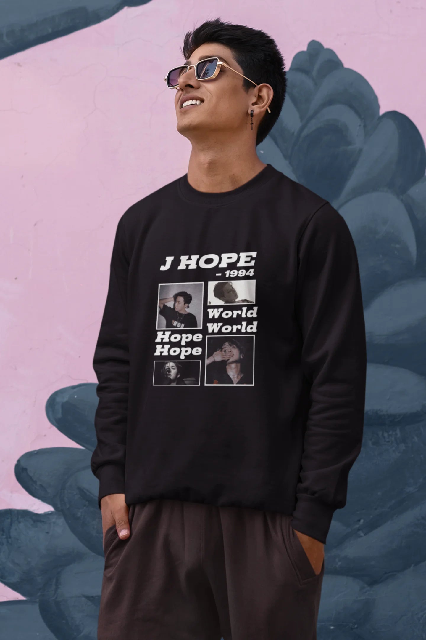 First front view of a male model wearing a black sweatshirt featuring a vibrant design inspired by BTS member J-Hope (Hoseok). Ideal for BTS fans (ARMY) and K-Pop enthusiasts who love dance and rap-focused music.