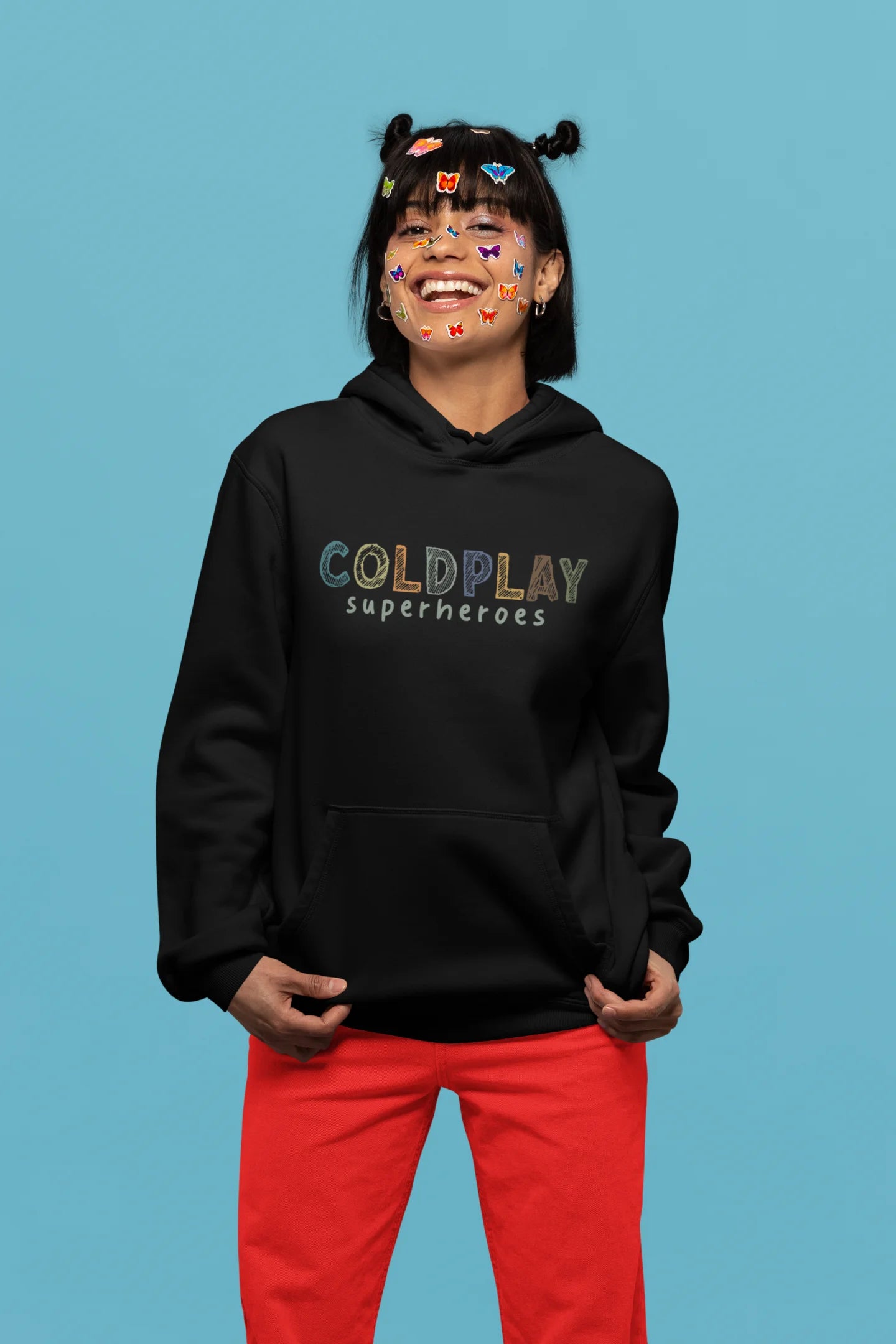 1st front view of a female model wearing an black hoodie with a design inspired by the "Something Just Like This" music video, featuring the word "Superheroes".