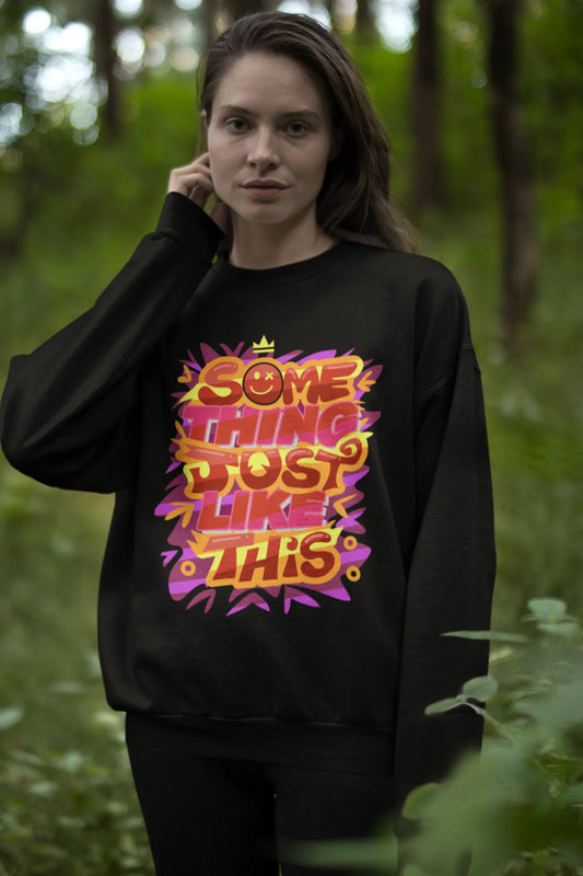 First front view of a female model wearing an black sweatshirt featuring the designs inspired from Coldplay's "Something Just Like This" music video.