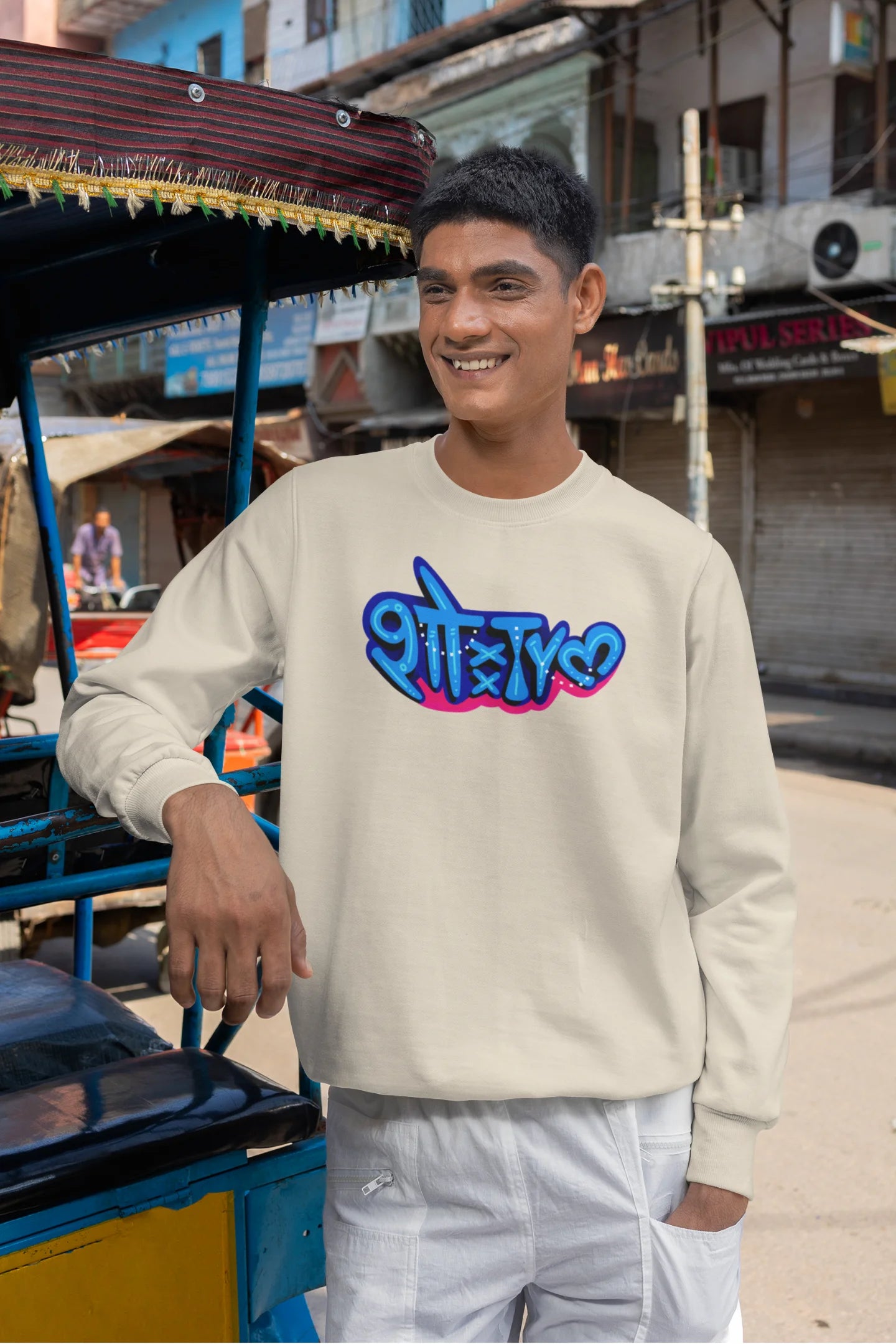 3rd front view of a male model wearing a cream oversized t-shirt featuring "Showtime" in Hindi.