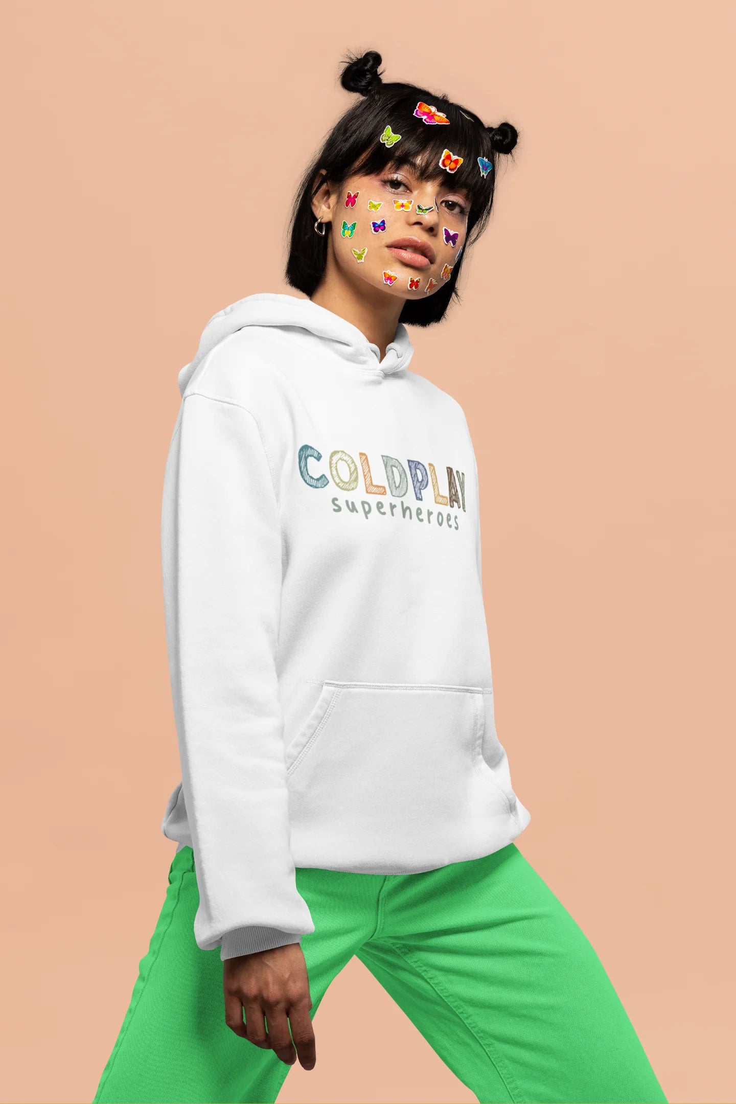 4th front view of a female model wearing an off-white hoodie with a design inspired by the "Something Just Like This" music video, featuring the word "Superheroes".