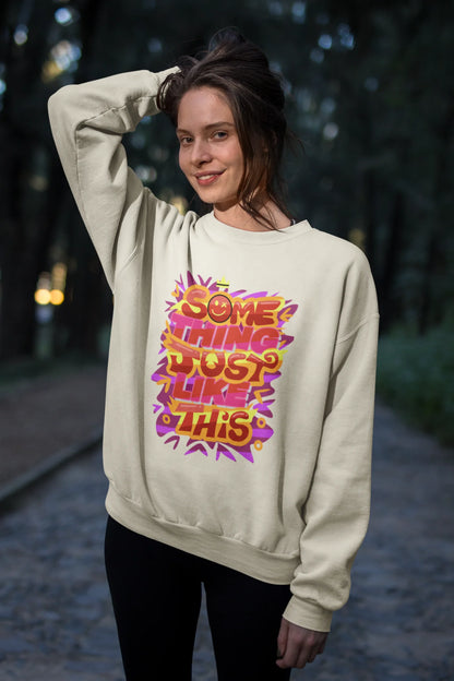 Fourth front view of a female model wearing an cream sweatshirt featuring the designs inspired from Coldplay's "Something Just Like This" music video.