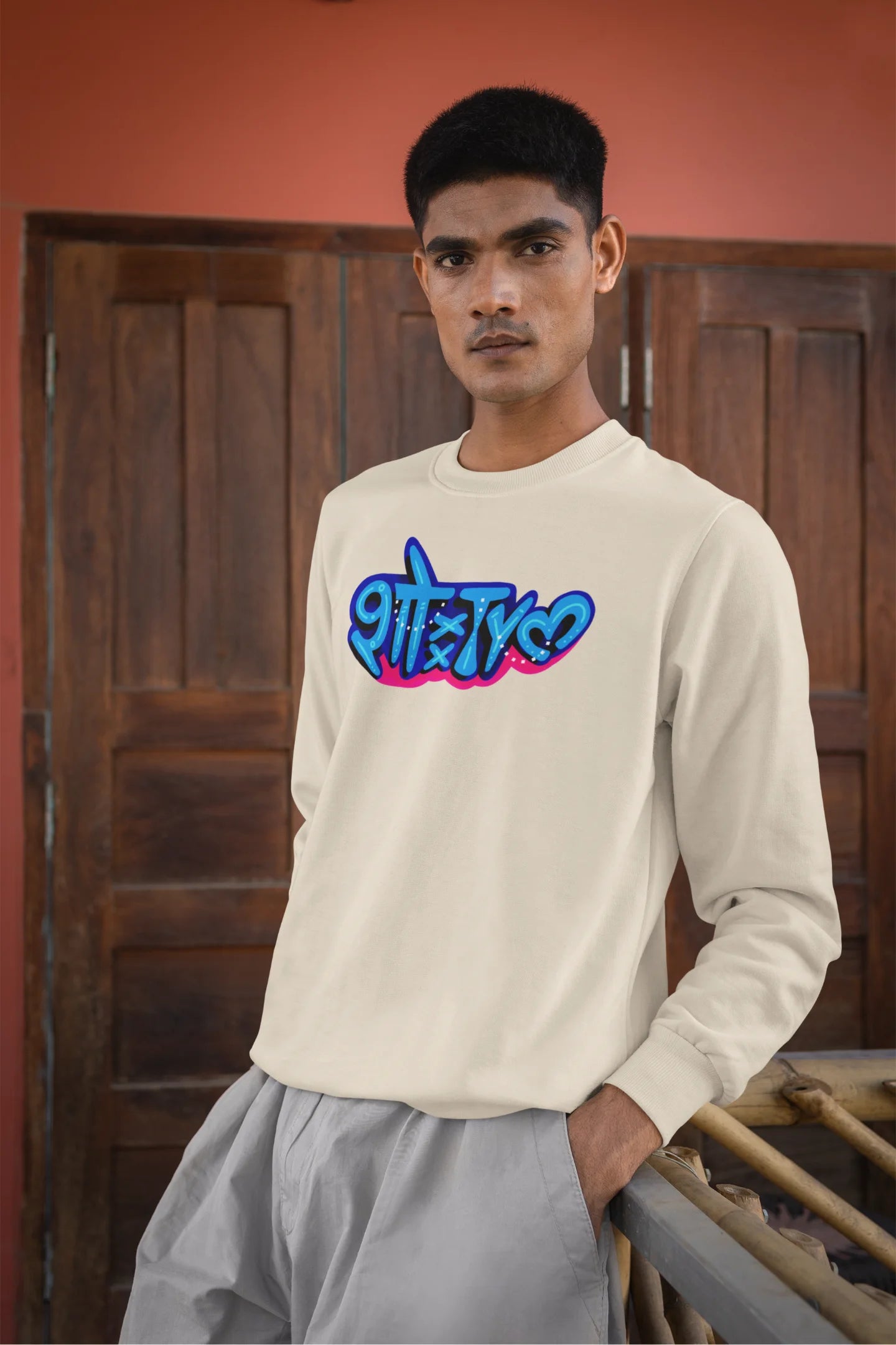 4th front view of a male model wearing a cream oversized t-shirt featuring "Showtime" in Hindi.