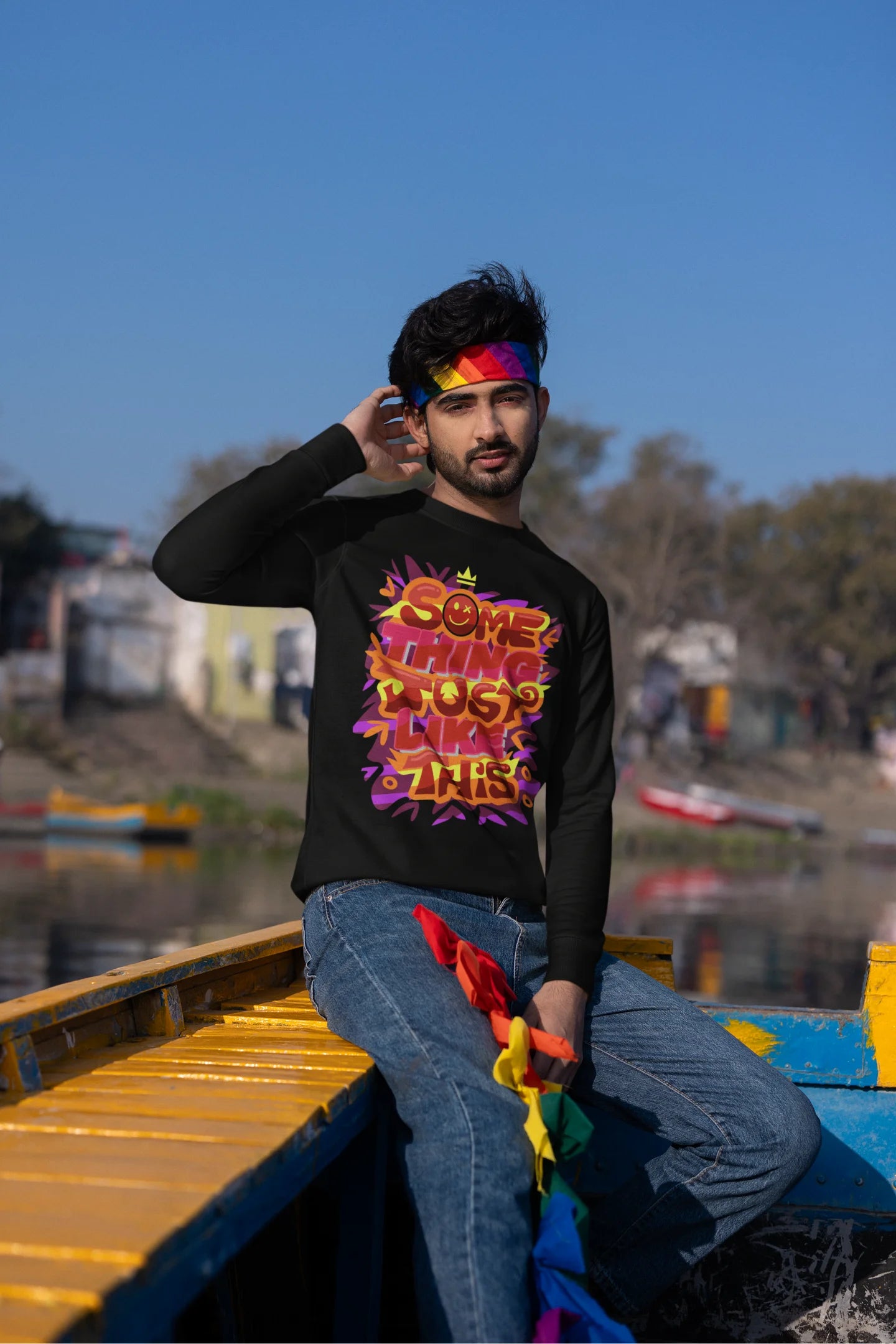 Second front view of a male model wearing an black sweatshirt featuring the designs inspired from Coldplay's "Something Just Like This" music video.