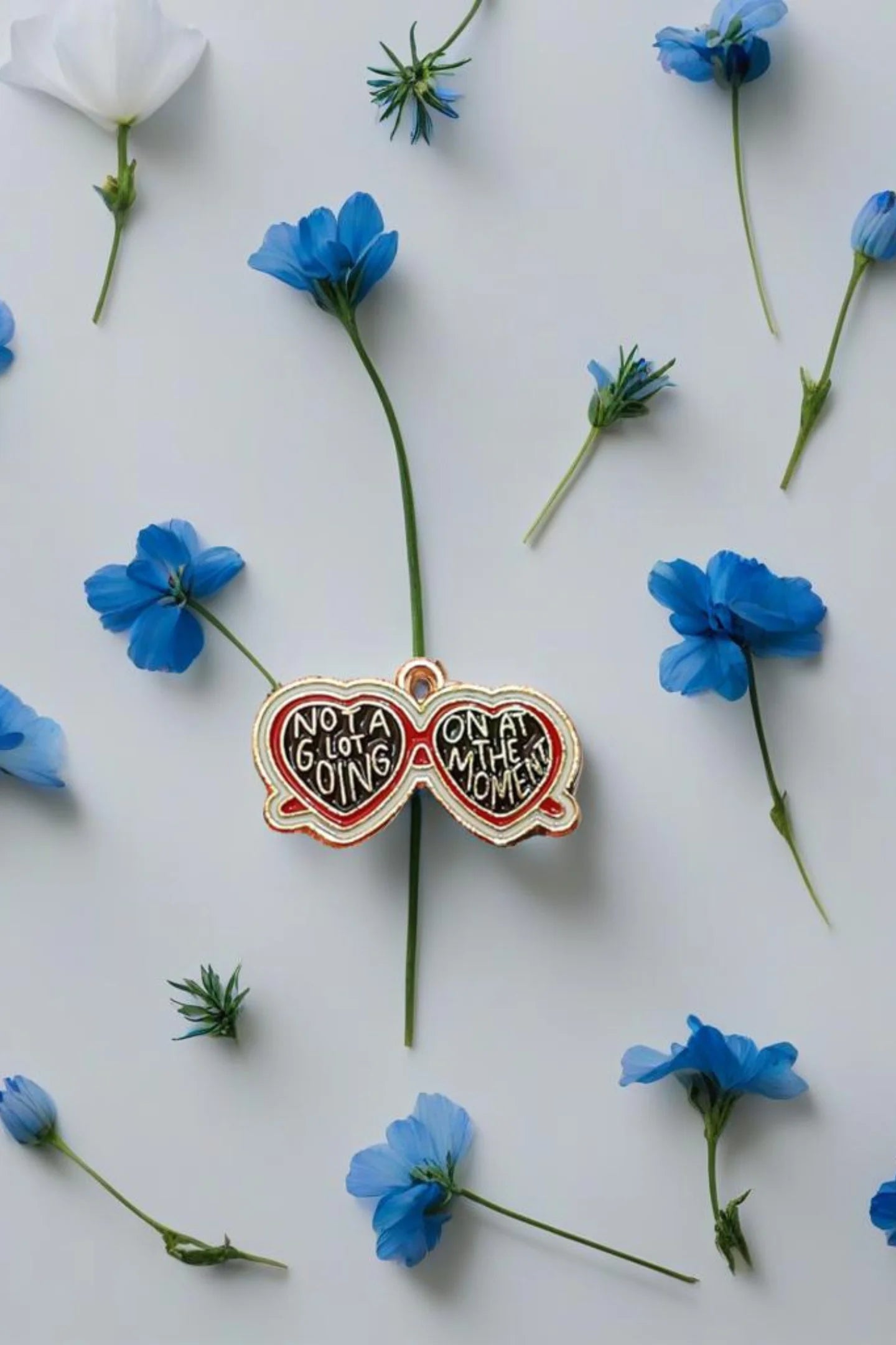 Third view of a charm featuring a design inspired by Taylor Swift's "Evermore" album.