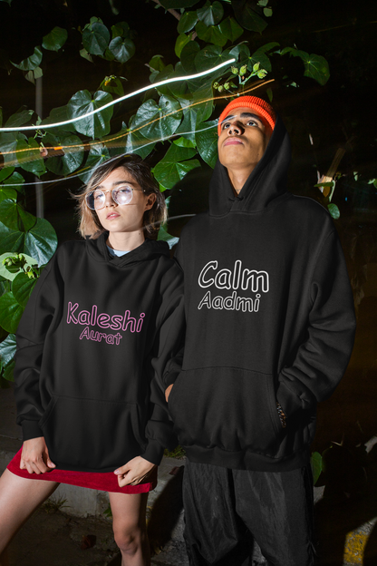  A cool couple wearing matching hoodies, one with "Calm one" and the other with "Chaotic one" printed on them in Hindi.