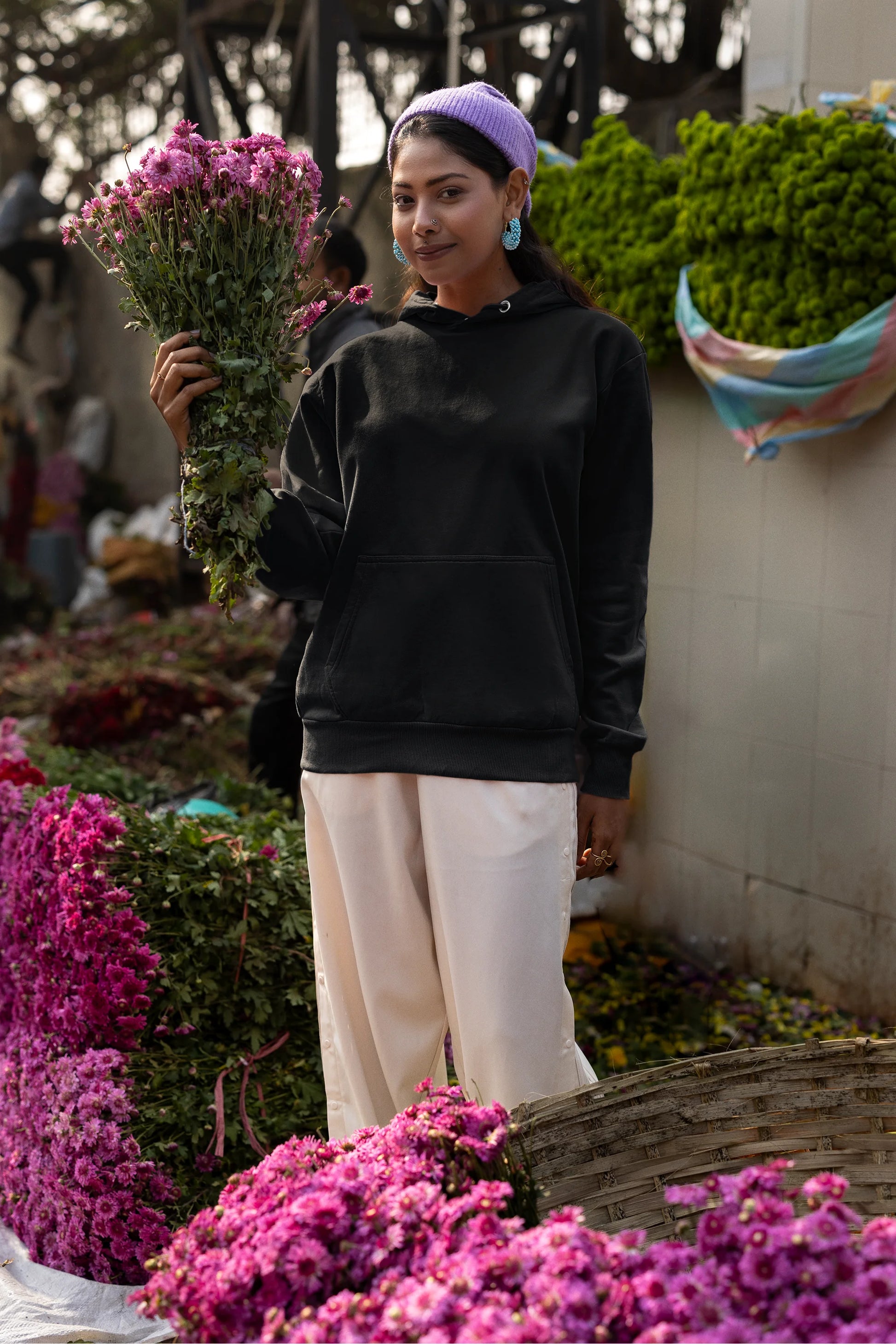 Second front view of a female model wearing a black hoodie with a Japanese art style tiger design.