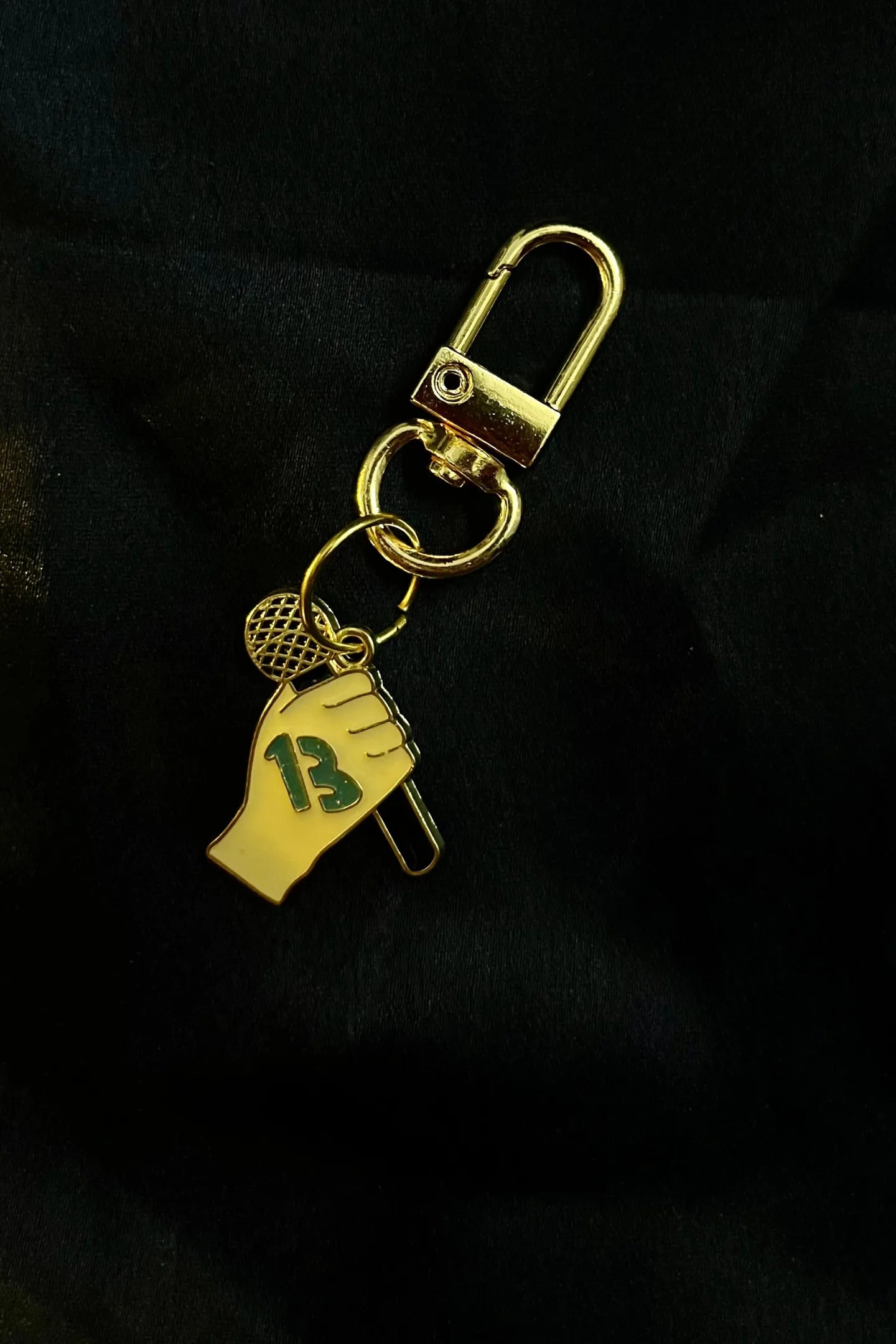 Fourth view of a keychain featuring the number thirteen, symbolizing Taylor Swift's lucky number.