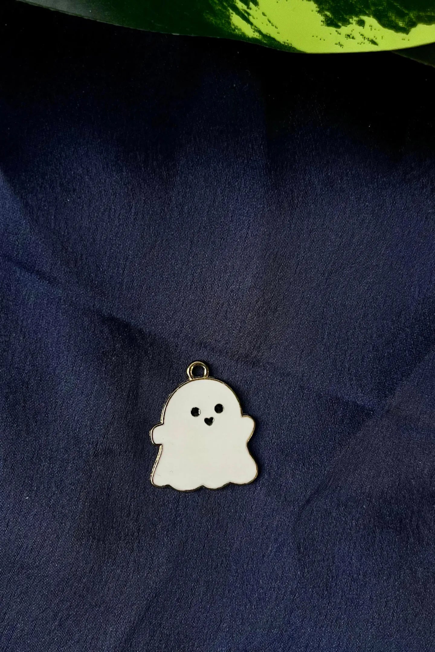 Second view of a charm featuring a cute white spooky adorable ghost design.