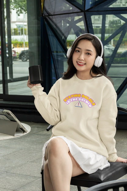 2nd front view of female model wearing a cream sweatshirt with the hilarious message "Stay Delulu" in a bold design. Ideal for those who love trendy slang and lighthearted humor.