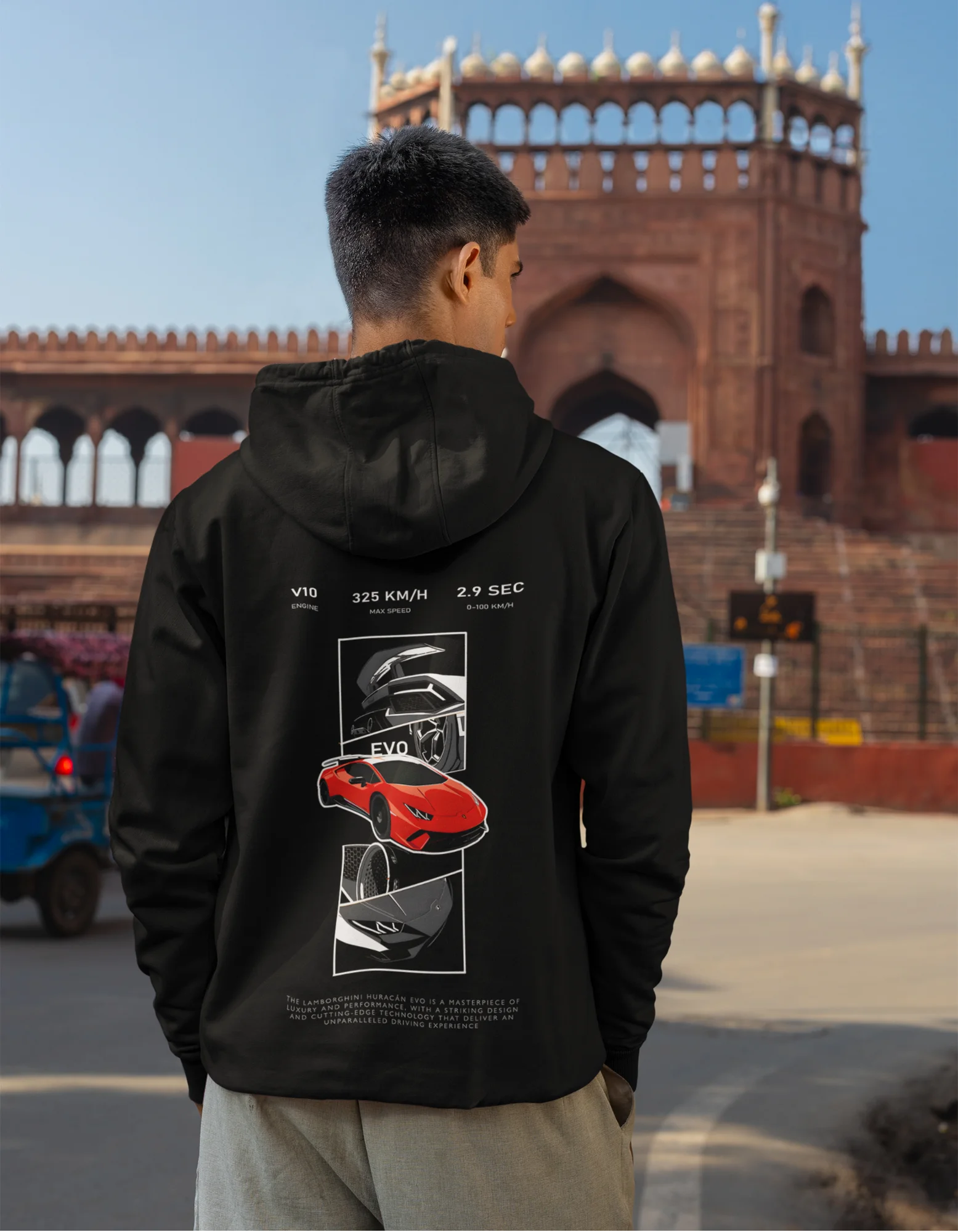 Back view of a male model wearing a black hoodie featuring a Lamborghini Huracan design, exuding speed and power.