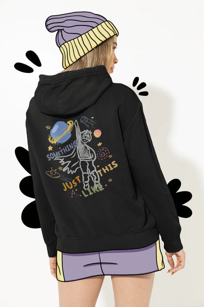 Back view of a female model wearing an black hoodie with a design inspired by the "Something Just Like This" music video, featuring the word "Superheroes".
