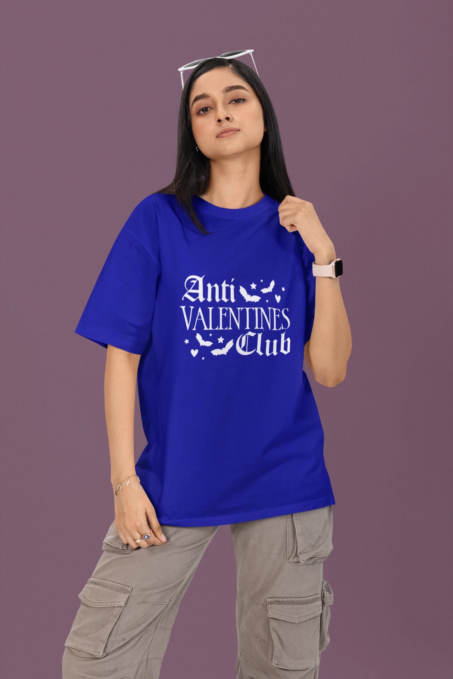 2nd front view of a female model wearing a royal blue oversized t-shirt with the text "Anti-Valentine's Club" printed on it.