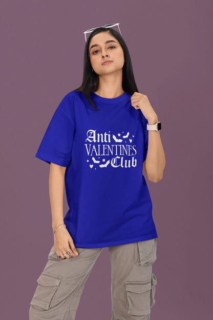 2nd front view of a female model wearing a royal blue oversized t-shirt with the text "Anti-Valentine's Club" printed on it.