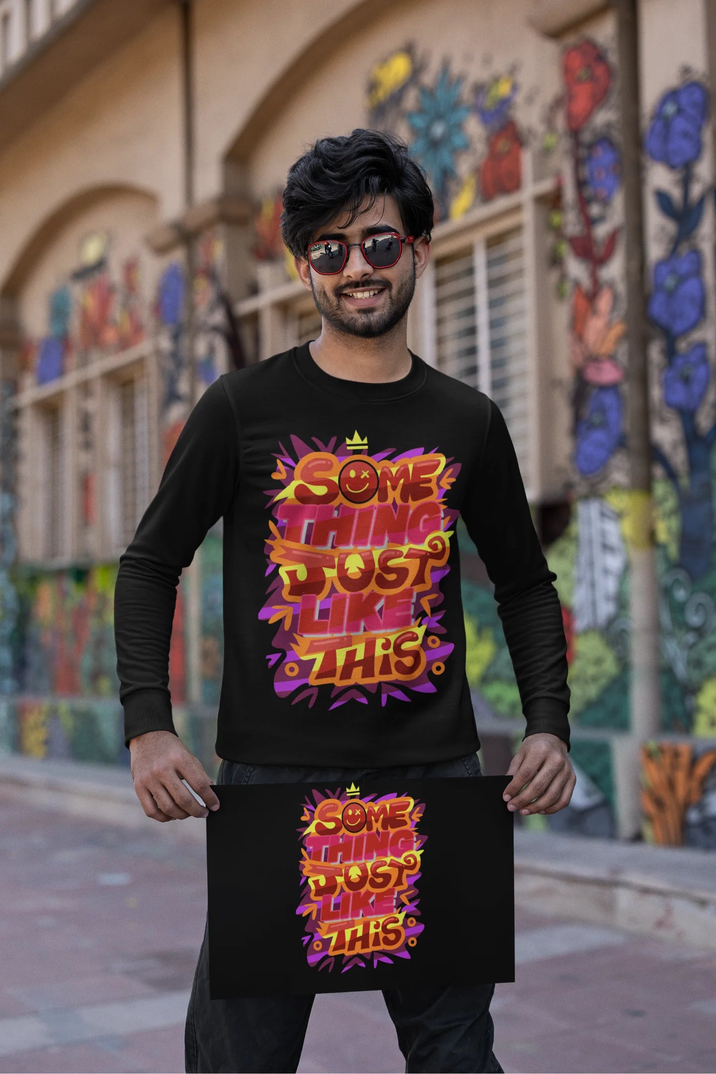 First front view of a male model wearing an black sweatshirt featuring the designs inspired from Coldplay's "Something Just Like This" music video.