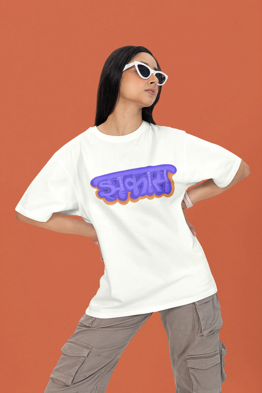 2nd front view of a female model wearing an off-white oversized t-shirt featuring "Jhakas" in a stylish font.