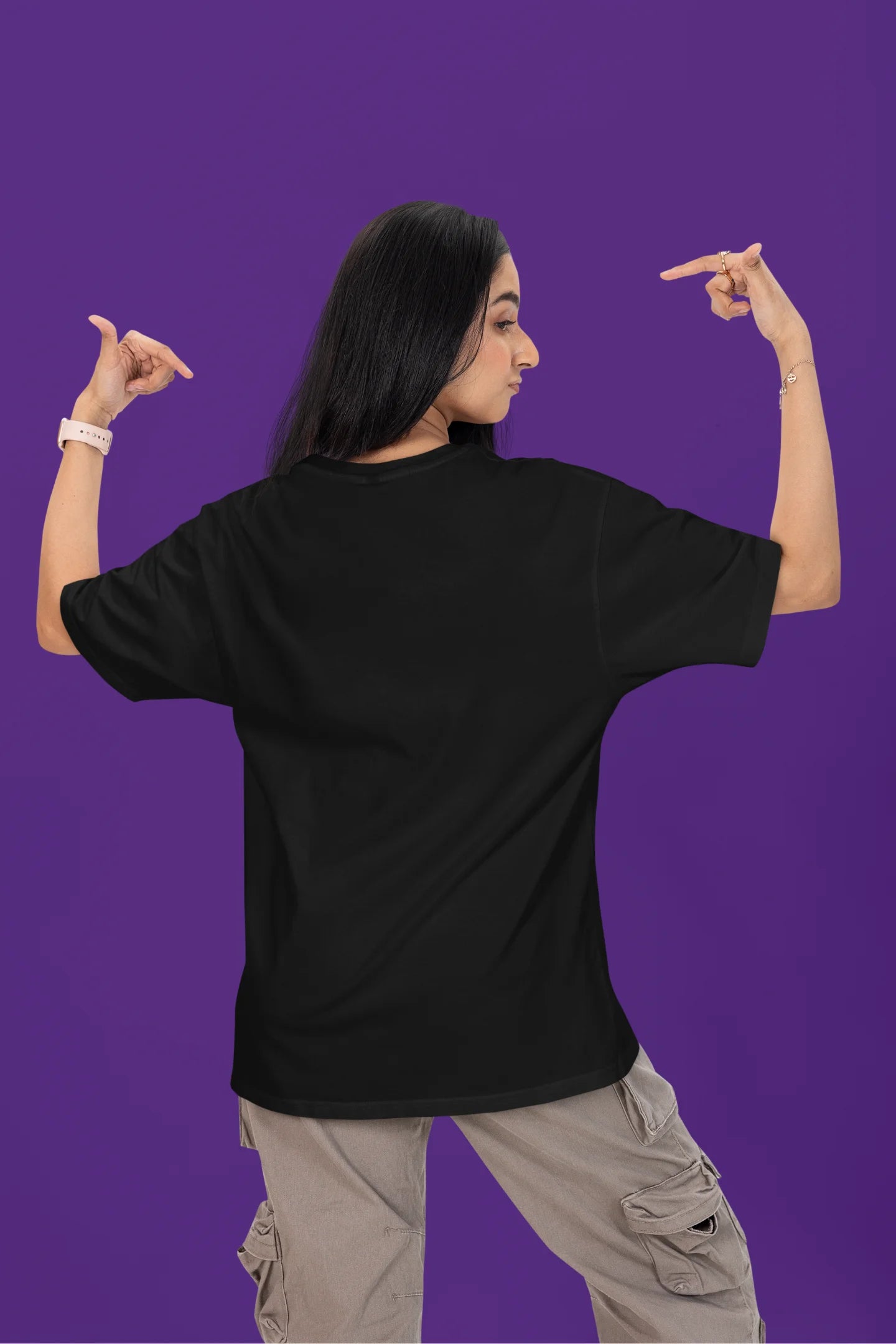 Back view of a female model wearing a black oversized t-shirt with the text "Anti-Valentine's Club" printed on it.