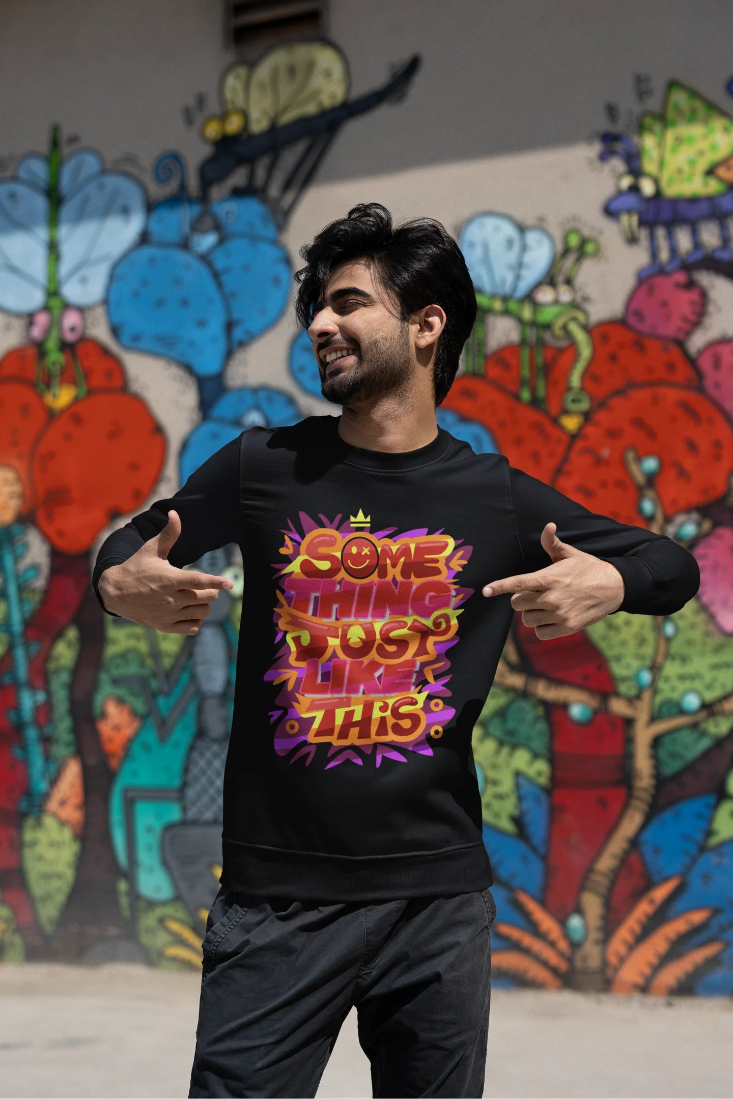 Third front view of a male model wearing an black sweatshirt featuring the designs inspired from Coldplay's "Something Just Like This" music video.