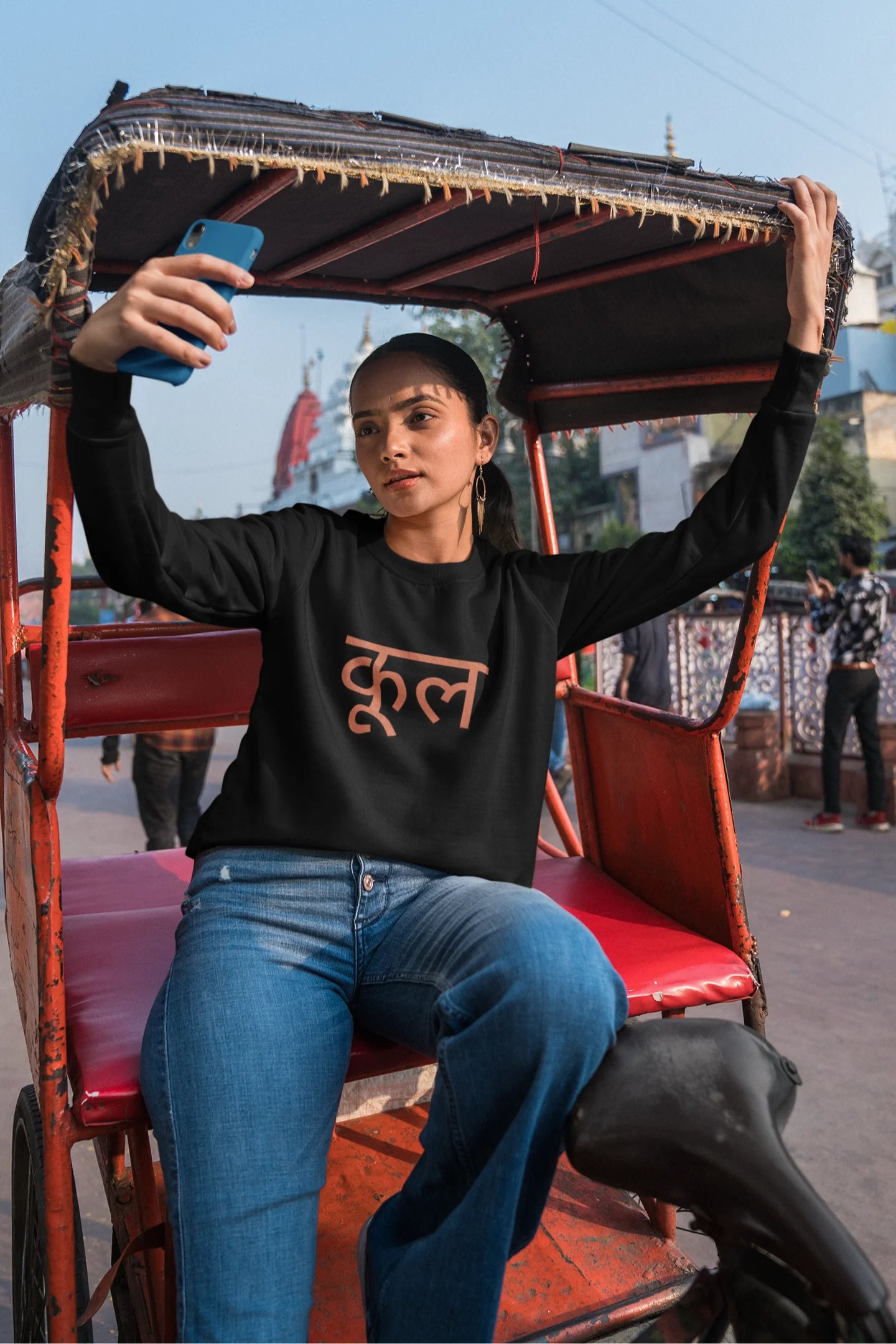 5th front view of a female model wearing a black oversized t-shirt featuring the Hindi word for "cool" with a unique, playful design.