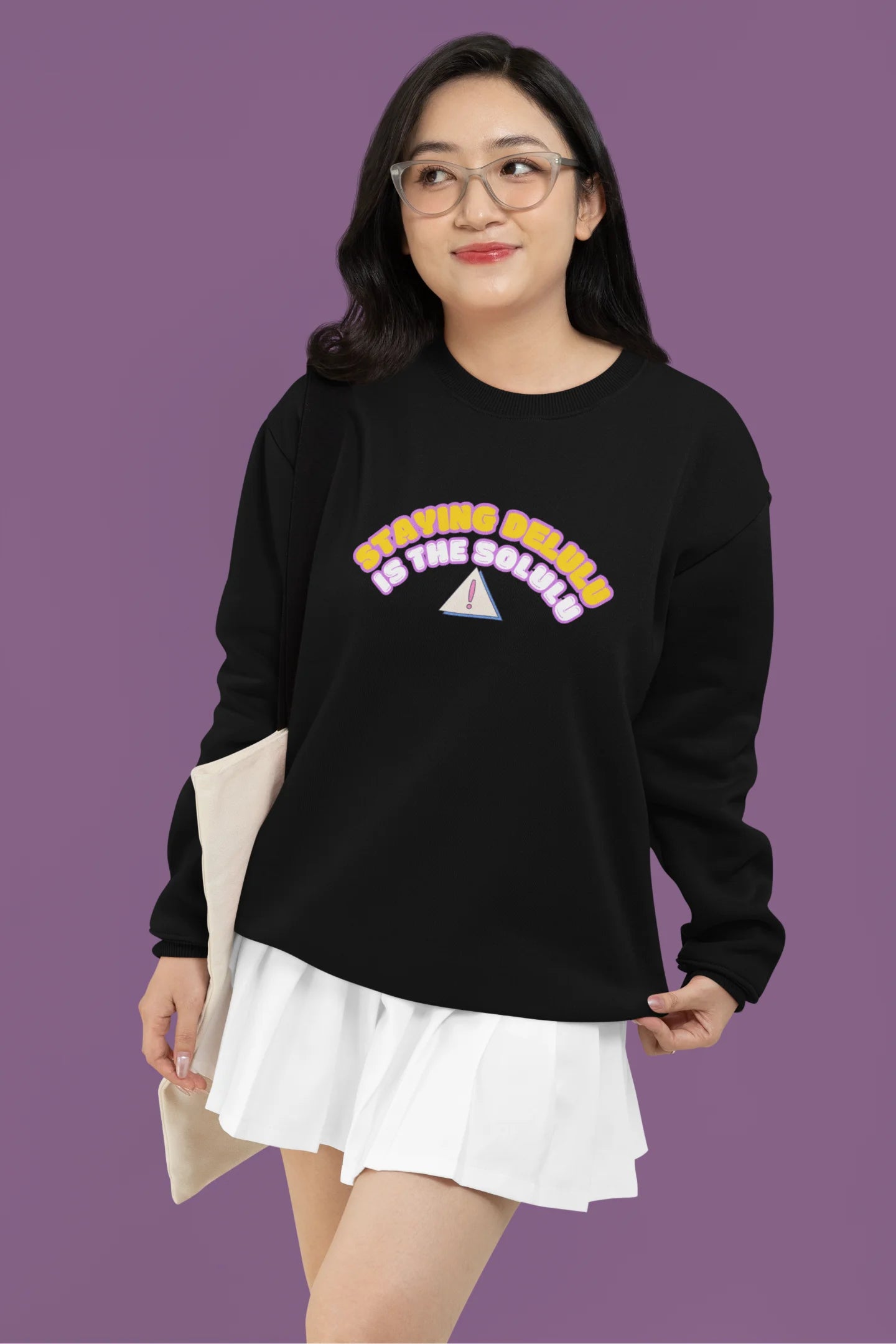 2nd front view of female model wearing a black sweatshirt with the hilarious message "Stay Delulu" in a bold design. Ideal for those who love trendy slang and lighthearted humor.