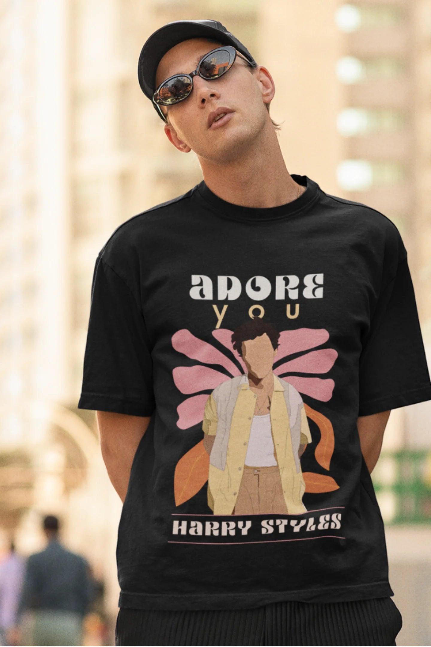 Second image of man wearing black oversized t-shirt featuring 'Adore You' inspired design - ideal for fans of Harry Styles and One Direction