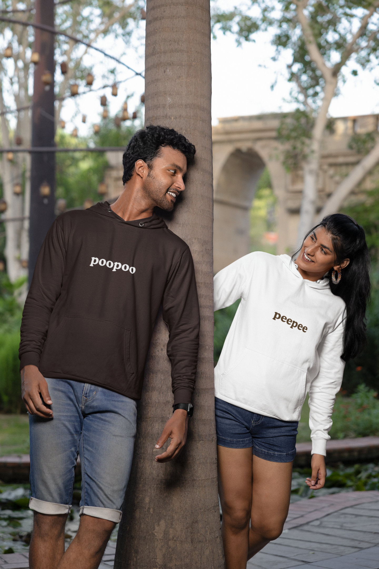 3rd front view of a couple wearing matching hoodies, one with the word "PeePee" and the other with the word "PooPoo".